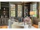 Charming sitting room featuring built-in bookcases, hardwood floors, and shuttered windows at 1919 Kensal Ct, Charlotte, NC 28211