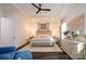 Bright bedroom with a king-size bed, dresser, and ceiling fan at 216 Portrait Way, Indian Trail, NC 28079