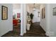 Bright and spacious hallway with dark hardwood floors and artwork at 216 Portrait Way, Indian Trail, NC 28079