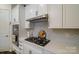 Well-equipped kitchen with white cabinets and gas range at 216 Portrait Way, Indian Trail, NC 28079