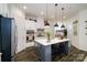 Bright kitchen featuring an island, stainless steel appliances, and hardwood floors at 216 Portrait Way, Indian Trail, NC 28079