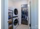 Laundry room with washer, dryer, and built-in shelving at 216 Portrait Way, Indian Trail, NC 28079