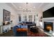 Relaxing living room with sectional sofa, fireplace, and large windows offering natural light at 216 Portrait Way, Indian Trail, NC 28079