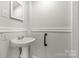 Small bathroom with pedestal sink and grab bar at 305 N White St, Lancaster, SC 29720