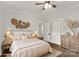 Comfortable bedroom featuring a ceiling fan, a bed with plush pillows, and hardwood floors at 305 N White St, Lancaster, SC 29720