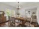 Bright dining room with chandelier, decorative windows, and a door that leads to the kitchen at 305 N White St, Lancaster, SC 29720