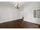 Light-filled dining room with hardwood floors, elegant chandelier, and classic built-in cabinetry at 305 N White St, Lancaster, SC 29720