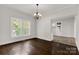 Bright dining room featuring hardwood floors, chandelier, and large windows bringing in natural light at 305 N White St, Lancaster, SC 29720