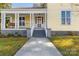 Charming yellow house with front porch and landscaping at 305 N White St, Lancaster, SC 29720