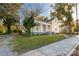 House exterior with a yellow facade and mature trees at 305 N White St, Lancaster, SC 29720