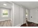 Bright hallway featuring modern doorframes, hardwood flooring, and ample natural light from the window at 305 N White St, Lancaster, SC 29720