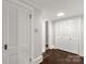 Spacious hallway with hardwood floors, traditional doors, and ample storage in closet at 305 N White St, Lancaster, SC 29720