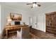 Home office featuring built-in shelving and hardwood floors at 305 N White St, Lancaster, SC 29720