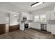 Modern kitchen features white cabinets, stainless steel appliances, backsplash, and hardwood flooring at 305 N White St, Lancaster, SC 29720