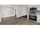 Modern kitchen with stainless steel oven, tile backsplash, granite countertop, and wood-look floor at 305 N White St, Lancaster, SC 29720