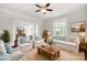 Comfortable living room with natural light, ceiling fan, and hardwood floors at 305 N White St, Lancaster, SC 29720