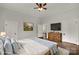 Staged main bedroom with hardwood floors, ceiling fan, television, and natural light at 305 N White St, Lancaster, SC 29720