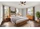 Bright and airy main bedroom featuring hardwood floors, a ceiling fan, and natural light from surrounding windows at 305 N White St, Lancaster, SC 29720