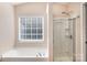 Bright bathroom featuring a soaking tub and a separate glass-enclosed shower at 4707 Hannah Dr, Rock Hill, SC 29732