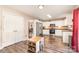 Bright and airy kitchen boasts white cabinetry and stainless steel appliances, adjacent to dining and living spaces at 4707 Hannah Dr, Rock Hill, SC 29732