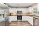 Well-lit kitchen featuring white cabinets, stainless steel appliances, ample counter space, and hardwood flooring at 4707 Hannah Dr, Rock Hill, SC 29732