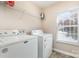 Well-equipped laundry room with a washer, dryer, and storage shelves. A functional space for household chores at 4707 Hannah Dr, Rock Hill, SC 29732