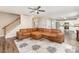 Spacious living room with modern ceiling fan, staircase, and an open view into the adjacent kitchen area at 4707 Hannah Dr, Rock Hill, SC 29732