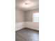 Well-lit bedroom with grey walls and wood-look floors at 5105 Chelsey Ln, Monroe, NC 28110