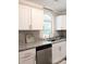 Modern kitchen with white cabinets, granite countertops, and a large window at 5105 Chelsey Ln, Monroe, NC 28110