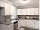 Modern kitchen with white cabinets, granite countertops, and stainless steel appliances at 5105 Chelsey Ln, Monroe, NC 28110