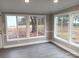 Bright sunroom features ample windows and wood-look flooring at 5105 Chelsey Ln, Monroe, NC 28110