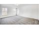 Well-lit bedroom featuring grey carpet and two windows at 5226 Verona Rd # 81, Charlotte, NC 28213