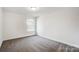 Bright bedroom with grey carpet and a window at 5226 Verona Rd # 81, Charlotte, NC 28213