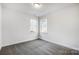 Spacious bedroom with grey carpet and two large windows at 5226 Verona Rd # 81, Charlotte, NC 28213