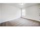 Bright bedroom with grey carpet and a window at 5226 Verona Rd # 81, Charlotte, NC 28213