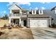 Two-story house with stone accents, a large garage, and a balcony at 5226 Verona Rd # 81, Charlotte, NC 28213