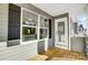 Exterior view of back porch with wood flooring and grey siding at 5226 Verona Rd # 81, Charlotte, NC 28213