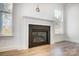 Modern fireplace with a dark mantel and light walls at 5226 Verona Rd # 81, Charlotte, NC 28213