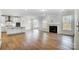 Open kitchen with white cabinets, island, and hardwood floors at 5226 Verona Rd # 81, Charlotte, NC 28213