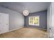 Bright bedroom with window and chandelier at 8428 Loxton Cir, Charlotte, NC 28214