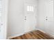 Bright entryway with white door, wood-look flooring, and crisp white walls at 112 Bickett Ave, Gastonia, NC 28052