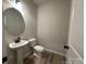 Simple bathroom with a pedestal sink, toilet, and wood-look floors at 11933 Cabera Ln, Midland, NC 28107