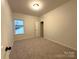 Bright bedroom with carpeted floor and large window at 11933 Cabera Ln, Midland, NC 28107