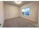 Simple bedroom with carpet and a large window at 11933 Cabera Ln, Midland, NC 28107