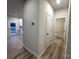 Clean hallway with light walls and wood-look floors at 11933 Cabera Ln, Midland, NC 28107