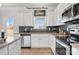 White kitchen with granite countertops and stainless steel appliances at 11933 Cabera Ln, Midland, NC 28107