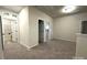 Upstairs hallway with carpet and doors to bedrooms and laundry at 11933 Cabera Ln, Midland, NC 28107