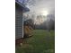 Large backyard featuring green grass and a wooden staircase leading to the yard at 401 Woodlawn Ave, Cramerton, NC 28032