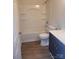 Well-lit bathroom featuring a bathtub with shower, sleek vanity, and modern fixtures at 401 Woodlawn Ave, Cramerton, NC 28032