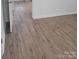 Wood-look flooring in a bright bedroom with neutral paint colors at 401 Woodlawn Ave, Cramerton, NC 28032